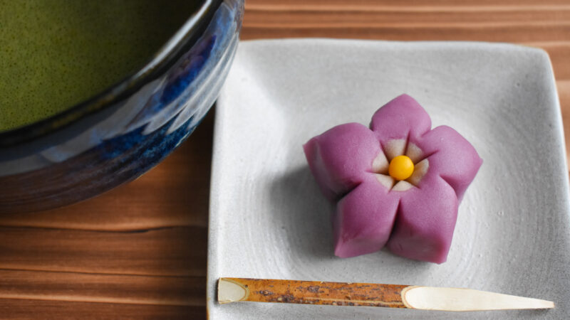 A purple flower-shaped Japanese sweet.