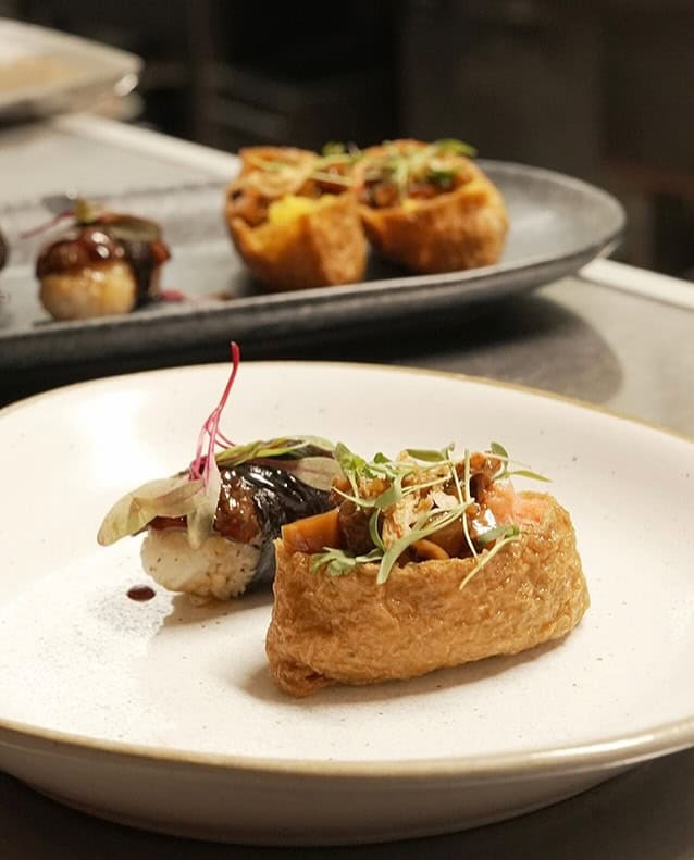 Fine dining plate featuring crispy fried shiitake preparation, braised mushroom accompaniment, and elegant microgreen garnish demonstrating Japanese mushroom culinary innovation at Third Kingdom restaurant