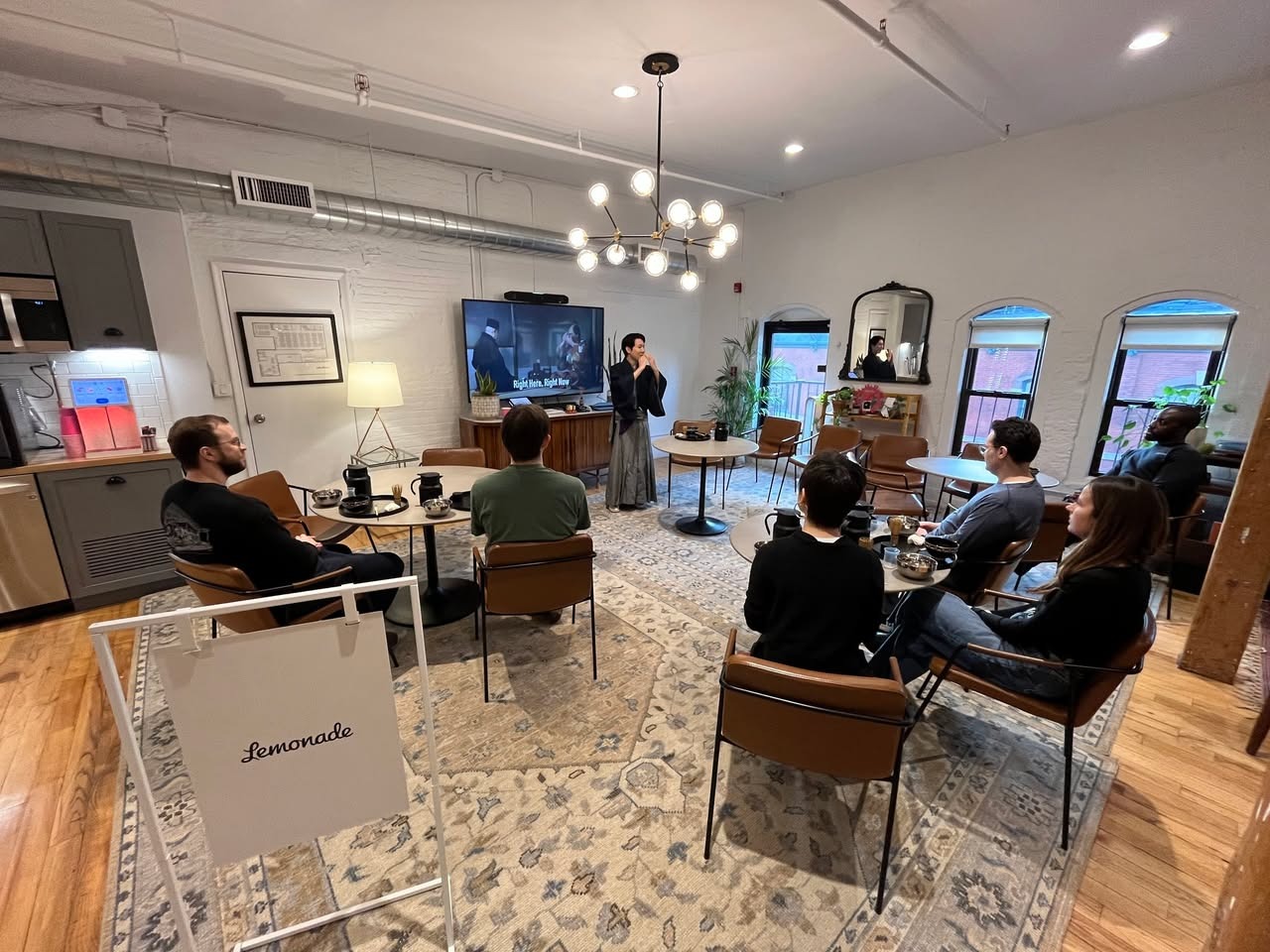 Japanese tea ceremony workshop at the Lemonade office, with a kimono-clad tea master presenting to seated employees