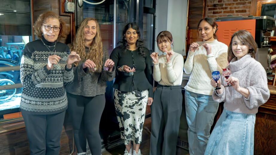 Students holding their finished mizuhiki works at the RESOBOX mizuhiki class