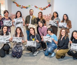 A group of participants proudly displaying their completed sumi-e ink paintings of Mount Fuji after a Japanese ink wash painting workshop