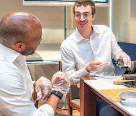 Two participants chatting and laughing while rolling decorative sushi together during a hands-on kazari maki zushi workshop