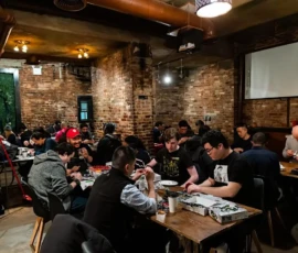 Group of Gunpla builders at work during a Project NuType build night event at RESOBOX